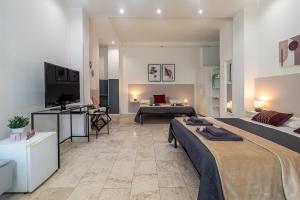 a large room with two beds and a television at Bologna Bed Station in Bologna +7 photos