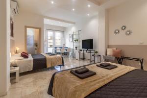 a bedroom with two beds and a living room at Bologna Bed Station in Bologna