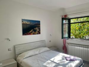 a bedroom with a bed and a window at Sorrento Realty Holidays - The smile of the sun in Sorrento