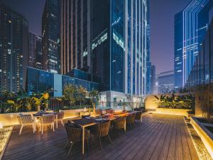 a rooftop patio with tables and chairs on a building at Atour Hotel Chengdu High-tech Tianfu 2nd Street in Chengdu