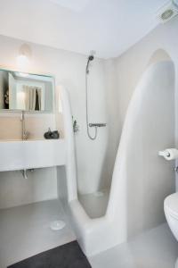 a white bathroom with a shower and a toilet at Hidden Gem Authentic cycladic house in Paros in Márpissa