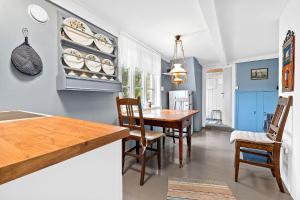 a dining room with a wooden table and chairs at Lite hus ved sjøen 