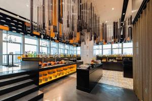 a bar in a hotel with a chandelier at Atour S Hotel Shanghai Lujiazui Financial Center in Shanghai