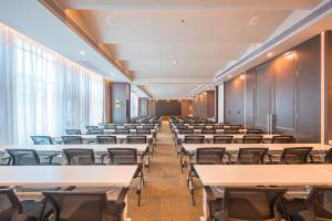 an empty lecture room with tables and chairs at Atour Hotel Shenzhen Baoan Vanke Star City in Bao'an