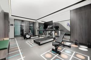 a gym with treadmills and exercise equipment in a room at Atour Hotel Jinan Yaoqiang International Airport in Jinan