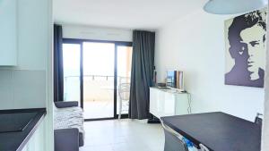 a room with a kitchen with a view of a balcony at Appartement 753, 4 personnes, vue mer By Palmazur in Cannes