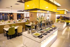 a buffet line with plates of food in a restaurant at Atour Hotel Xi'an Bell Tower North Street Station in Xi'an