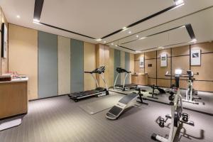 a gym with several exercise bikes and a mirror at Atour Hotel Xi'an Bell Tower North Street Station in Xi'an