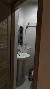 a small bathroom with a sink and a mirror at Hotel Tourist in Tbilisi City