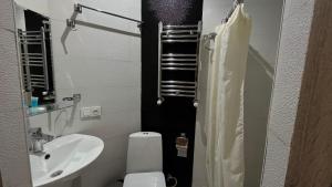 a small bathroom with a toilet and a sink at Hotel Tourist in Tbilisi City