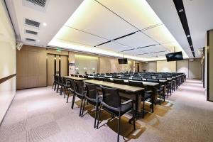 a conference room with rows of tables and chairs at Atour Hotel Changchun Automobile Development Zone in Changchun