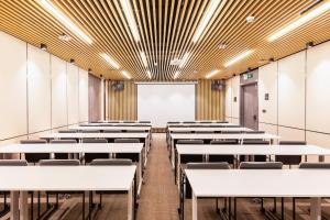 an empty classroom with white tables and chairs at Atour Hotel Shenzhen Baoan International Convention and Exhibition Center in Bao'an