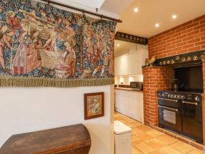 a kitchen with a tapestry hanging on the wall at Hop House in Hastings