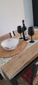 a bottle of wine and a plate on a table at Rental house in Dumbrăviţa