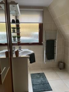 a bathroom with a sink and a window at Caledonia Lodge in Spean Bridge