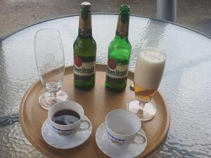 a table with two bottles and two glasses of beer at CARPE DIEM in Ryžoviště