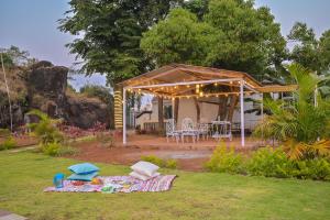 a backyard with a gazebo and a table and chairs at Infinity Pool 2bhk Villa with valley view in Panchgani