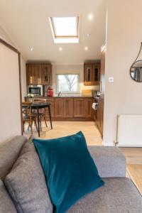 a living room with a couch and a kitchen at Ribblesdale Park in Gisburn