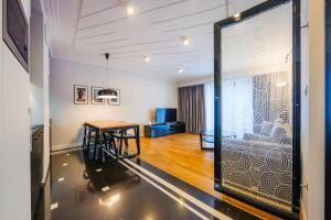 Cette chambre comprend une table et une porte en verre. dans l'établissement Apartamenty Sun & Snow Art Deco Gdynia, à Gdynia