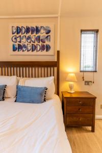a bedroom with two beds and a table with a lamp at Ribblesdale Park in Gisburn