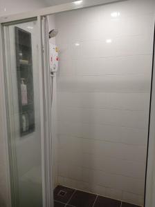 a shower with a glass door in a bathroom at BangKok Eyes in Bangkok