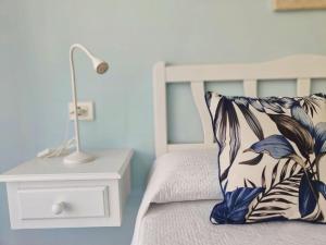 a bedroom with a bed with a pillow and a lamp at sol y mar in Puerto de Santiago
