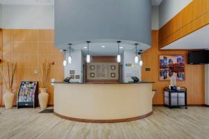 a lobby with a reception counter and vases at Comfort Suites Stockbridge Atlanta South in Stockbridge