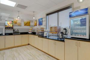 a fast food kitchen with a counter and a window at Comfort Suites Stockbridge Atlanta South in Stockbridge