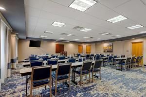 a conference room with tables and chairs in it at Comfort Suites Stockbridge Atlanta South in Stockbridge