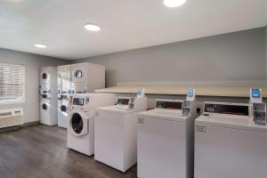 a laundry room with white washers and dryers at MainStay Suites Omaha Old Mill in Omaha