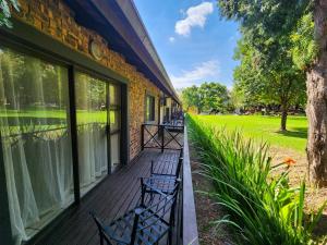a row of benches on the front porch of a building at The Venue Country Hotel & Spa in Hartbeespoort