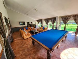 a large living room with a pool table in it at The Venue Country Hotel & Spa in Hartbeespoort