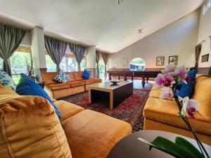 a large living room with couches and a piano at The Venue Country Hotel & Spa in Hartbeespoort