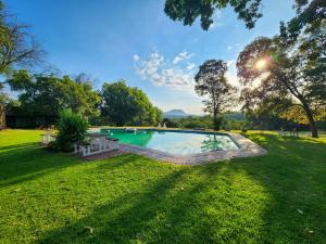 an image of a swimming pool in a yard at The Venue Country Hotel & Spa in Hartbeespoort