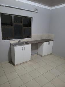 a kitchen with a sink and a counter at Mavundla lifestyle lodge in Empangeni