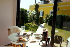 a table with food on it with a view of a yard at Villa Várzea - The Black Cabin in Várzea