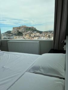 A bed or beds in a room at Majestic Acropolis-Lycabettus