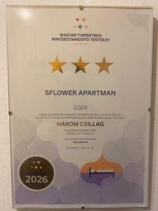 a sign for the shower apartmentarian with five stars at Sflower Apartman in Eger