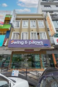a building with a purple sign on the front of it at Swing & Pillows - Subang SS15 in Subang Jaya