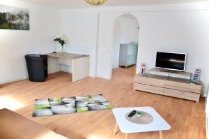 a living room with a couch and a tv at Ferienwohnung Casa Brandt in Villingen-Schwenningen +6 photos