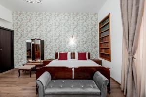 a bedroom with a large bed and a couch at VovaDoma in Tbilisi City