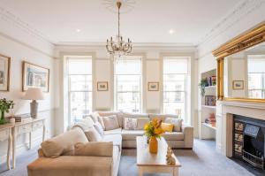 a living room with a couch and a fireplace at City Centre Stunning House-Roman Baths - 3min walk - 4 Bedrooms in Bath