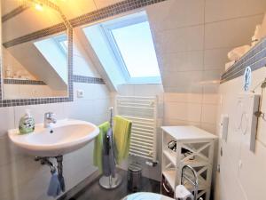 a bathroom with a sink and a skylight at Ferienwohnung Novotny in Jerrishoe