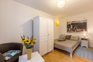 a small living room with a bed and a couch at Apartment Stella in Kaštela