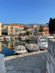 a group of boats are docked in a harbor at Apartment Stella in Kaštela