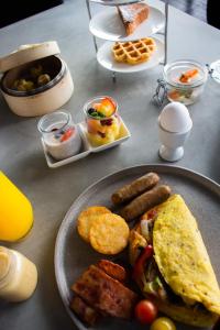 a table with a plate of food with breakfast foods at W Abu Dhabi - Yas Island in Abu Dhabi