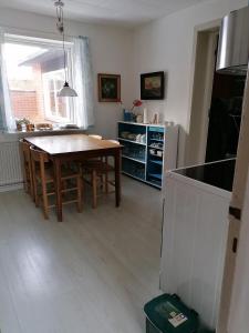 a kitchen with a wooden table and a dining room at B&B Tvolm Ydby Thy in Tvolm