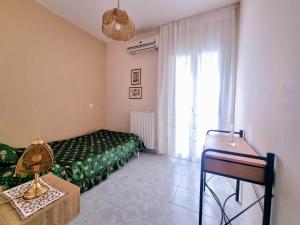 a bedroom with a green bed and a window at "Sun" Bayview apartment in Lixouri