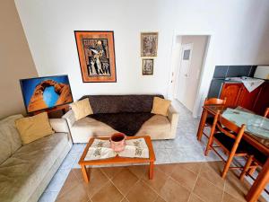 a living room with a couch and a table at "Sun" Bayview apartment in Lixouri