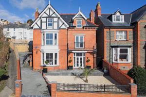 a large red brick house with a black roof at Townhouse No.1 in Aberystwyth